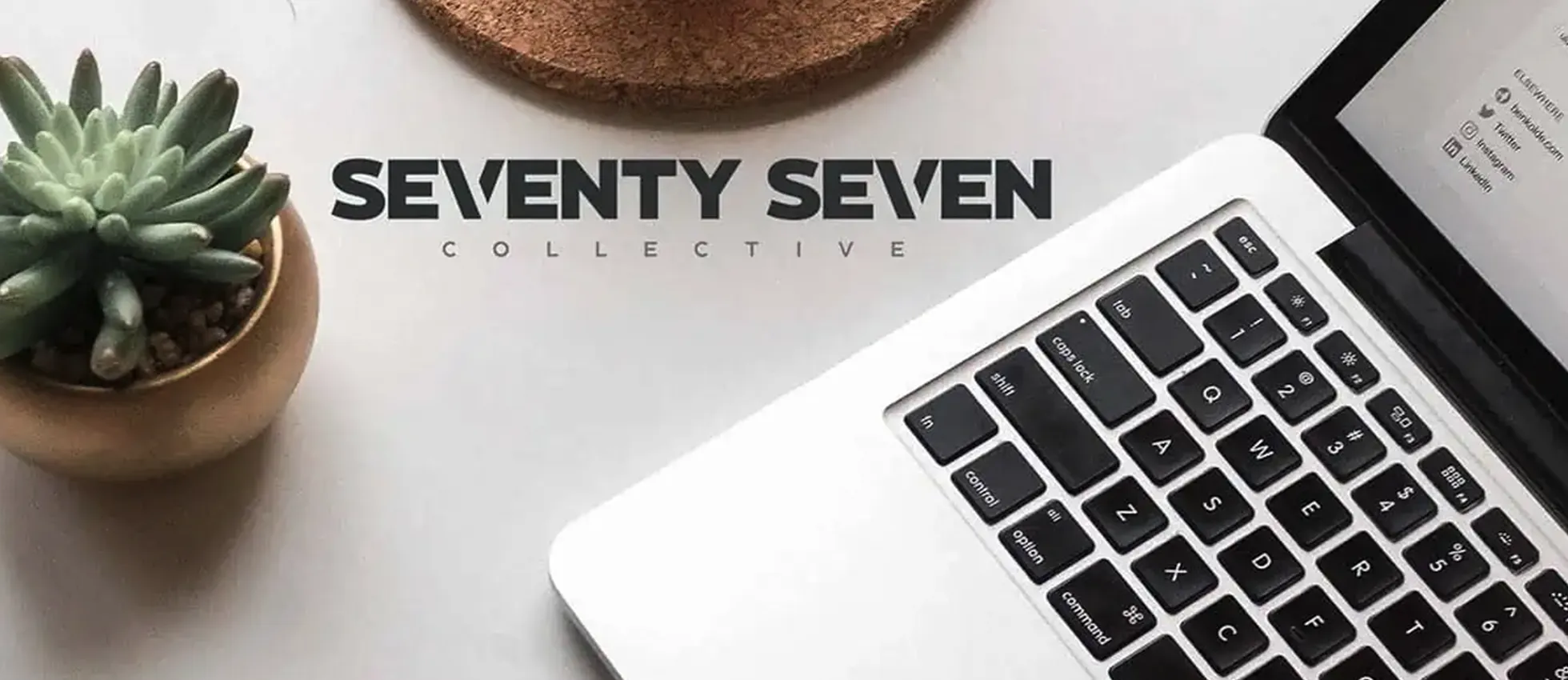 an image of the seventy seven collective logo next to a laptop