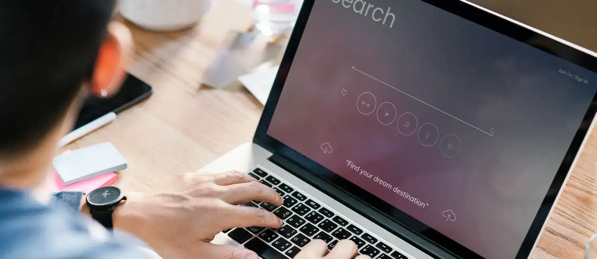 an image of a man typing in his laptop