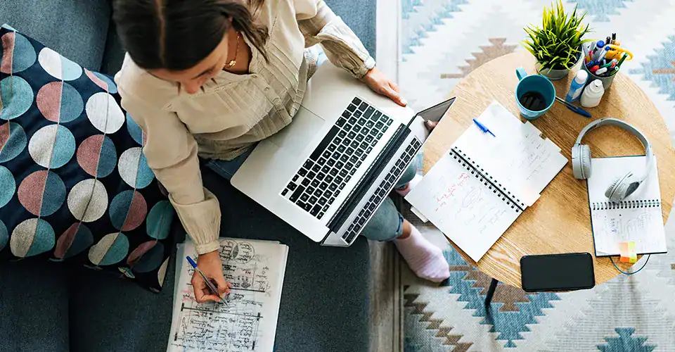woman on laptop taking notes