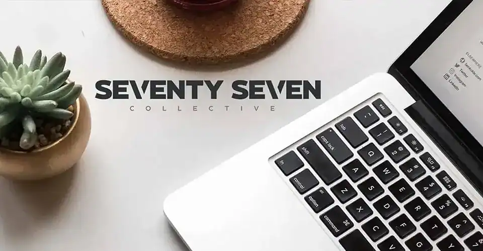 an image of the seventy seven collective logo next to a laptop