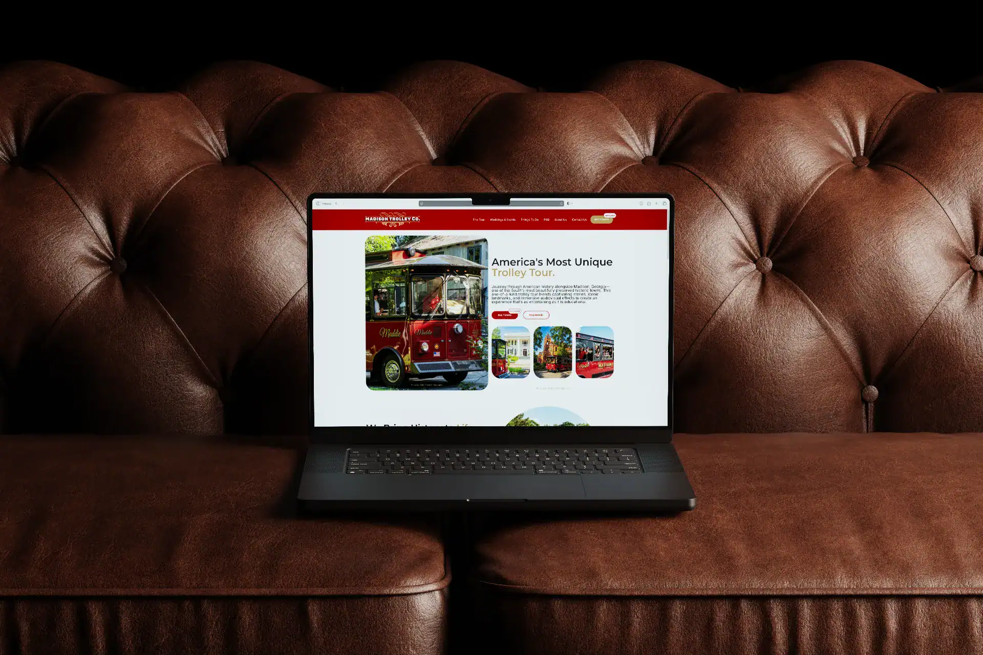 Vintage trolley bus on a laptop screen showcasing Seventy Seven Collective's transportation services.